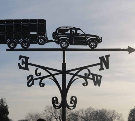 Car And Animal Trailer Weathervane made from stainless steel by blacksmiths in kent. A black weathervane against the sky in Kent