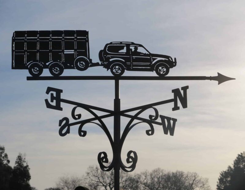 Car And Animal Trailer Weathervane made from stainless steel by blacksmiths in kent. A black weathervane against the sky in Kent