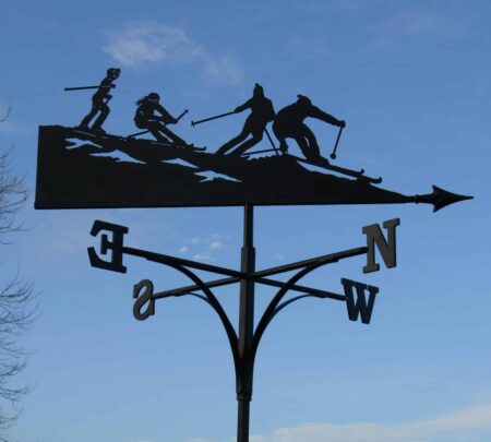 handmade black ski holiday weathervane showing 4 skiers in the alps on a black silhouette