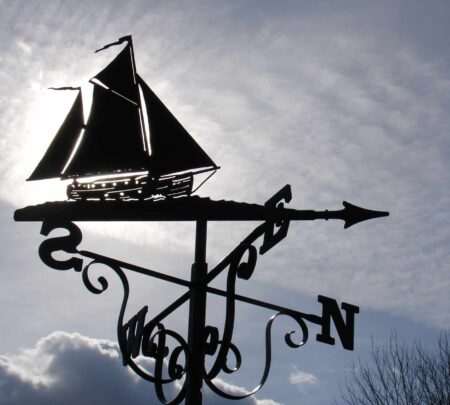 Ketch Yacht Boat Weathervane against a cloudy, grey sky