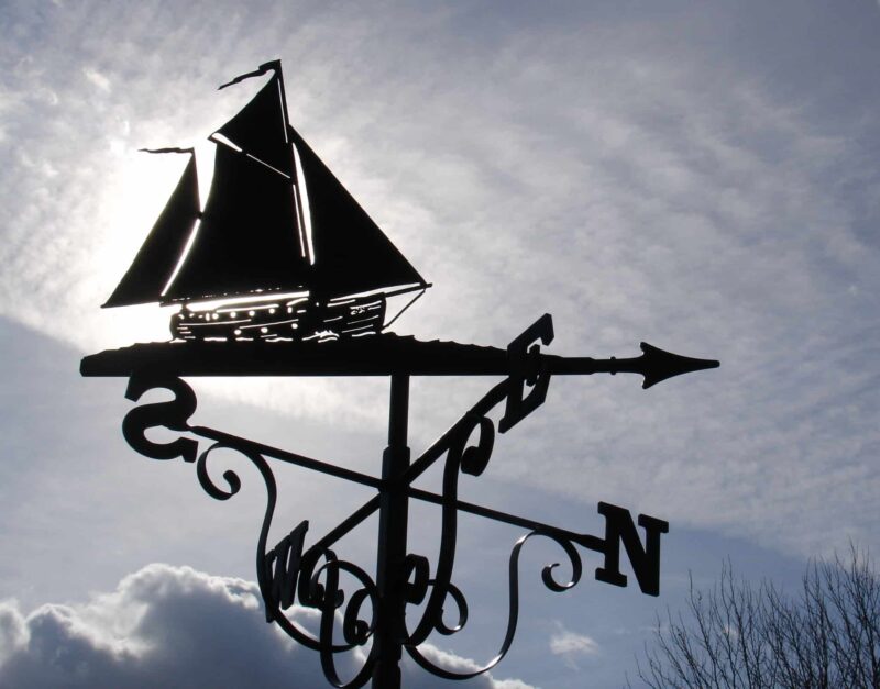 Ketch Yacht Boat Weathervane against a cloudy, grey sky