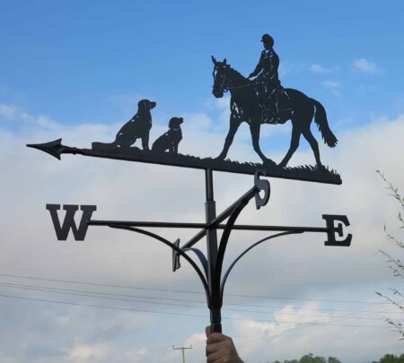 a black Dressage Horse Women And Dogs Weathervane against a blue sky in kent