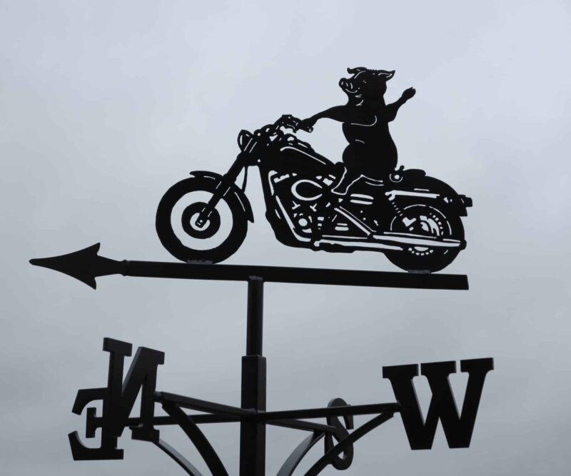 Harley Motorbike being ridden by a Pig Weathervane. Black stainless steel weathervane made by blacksmiths in kent.