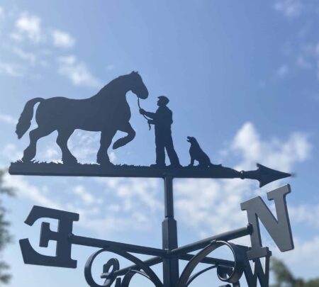 Shire Horse, Man & Labrador Weathervane against a blue sky with fluffy white clouds