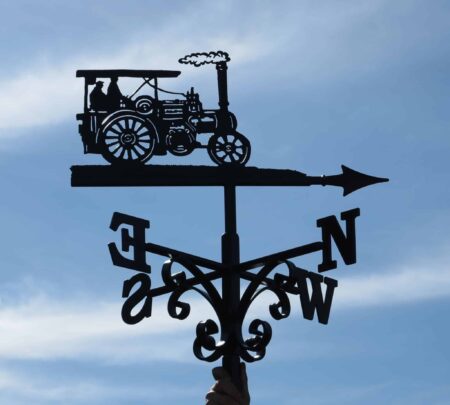 steam engine themed weathervane against a blue sky, painted black, made from 100% stainless steel by blacksmiths in kent.