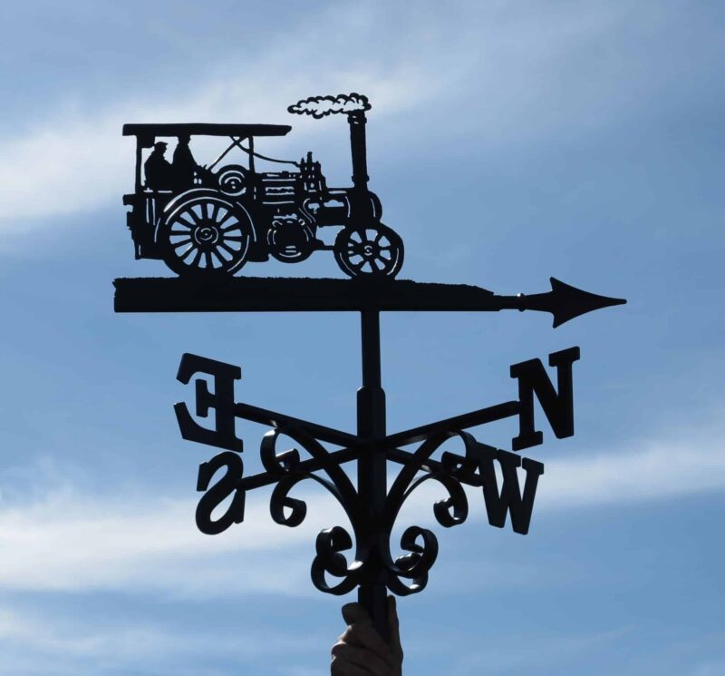 steam engine themed weathervane against a blue sky, painted black, made from 100% stainless steel by blacksmiths in kent.